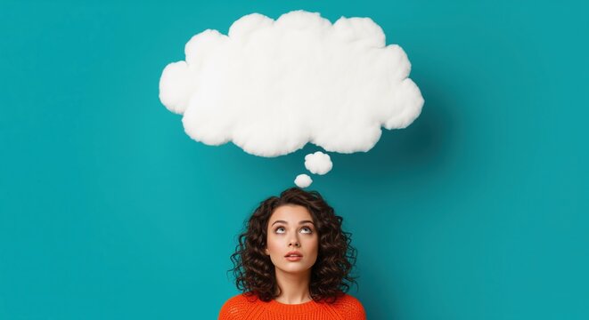 Young woman in orange sweater looking up at white thought bubble on turquoise background. Perfect for visualizing ideas, brainstorming, creativity, and positive thinking concepts.