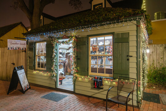 St. Augustine,FL,USA - Dec.30.2024: A small leather goods shop displays handmade belts, wallets, and accessories in St. Augustine, Florida. Christmas garland and colorful lights frame the open doorway