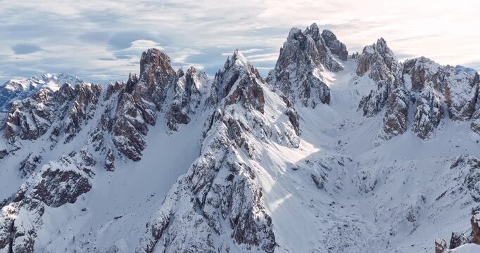 Aerial footage of a ski mountaineer in a snowy alpine ridge in Dolomites. Winter landscape, backcountry adventure, and solitude in breathtaking mountain scenery captured in 4K.