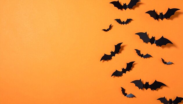 Flying Halloween bats silhouette, orange background, minimalist spooky design