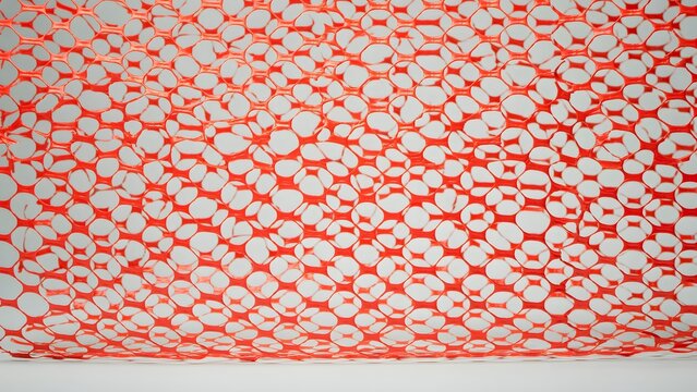 Close-up of rolled construction material with a honeycomb pattern in red and white colors