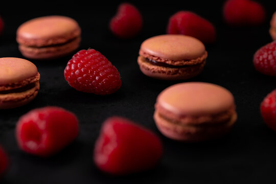 macaroons of different colors on a black background
