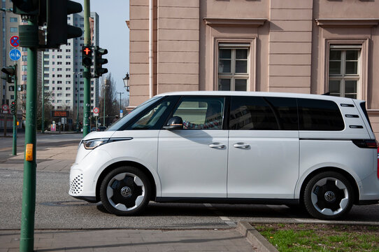 Potsdam, Brandenburg, Germany - February 26, 2024: Luxury electric minivan car Volkswagen Buzz. Car Volkswagen ID Buzz on road. White car, side view Volkswagen ID Buzz electric minivan MPV car