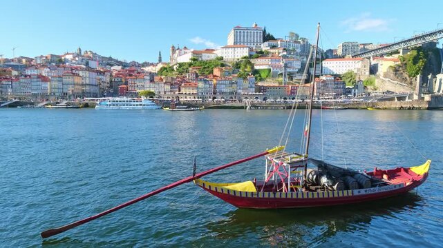 Rabelo boat on the Douro River near Porto Ribeira, Portugal, with riverside travel scene and Vila Nova de Gaia landmarks