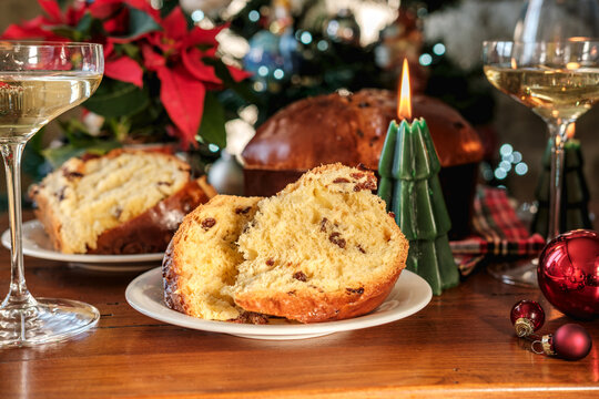 Christmas Panettone and Wine on a Festive Table With Candle, Poinsettia and Ornaments