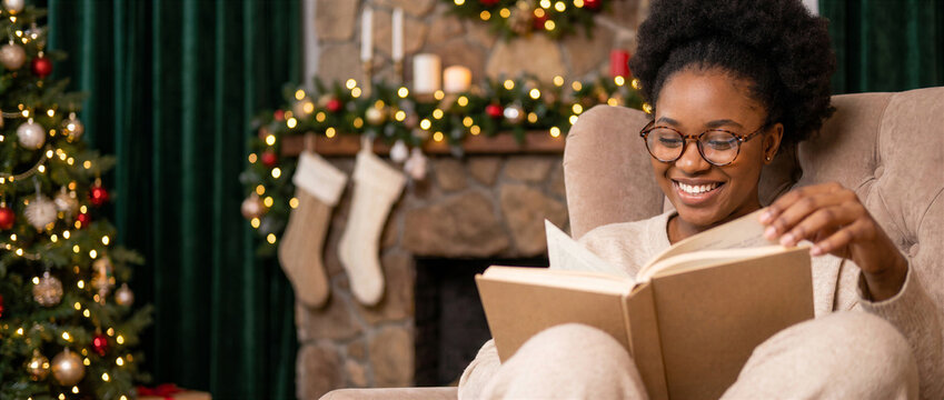 Afro American woman reading in glasses at Christmas