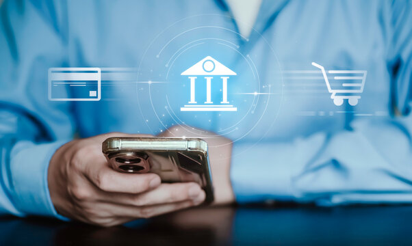 Digital banking and online shopping concept, financial transactions, e commerce, mobile banking, credit, debit and secure payment. person using smartphone with payment card. with light blue background