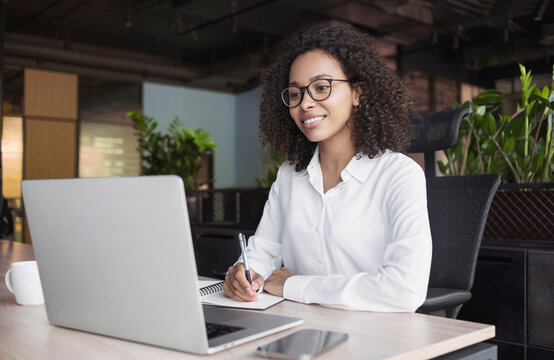 Young business woman using laptop computer at office, Student girl working looking at laptop. Work or study, freelance, business office lifestyle concept	