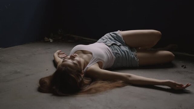 An unhappy young Asian woman with sickness and dizziness, stress, and shock-like, stroke-like symptoms, then fainted, lost consciousness, and collapsed, lying alone on the floor in a room at home. 