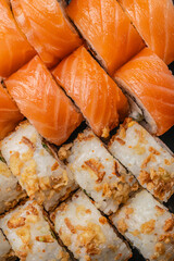 Closeup of orange raw fish slices layered over rice rolls with crispy golden toppings, detailed Japanese style sushi food texture and appetizing culinary presentation © Надія Коваль