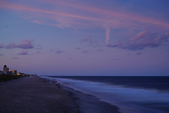 People fishing at Carolina Beach, North Carolina at sunset