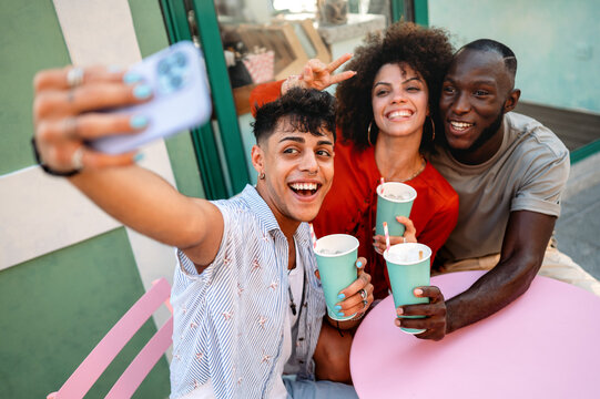 A group of multicultural university friends enjoys online shopping and fun moments together