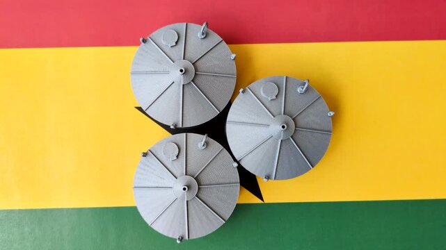 Liquefied gas storage tanks set against the Ghana flag. Liquefied gas tanks
