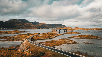 High angle view of winding coastal road and bridge connecting rocky islands in fjord landscape in Lofoten Norway © Quality by Simon