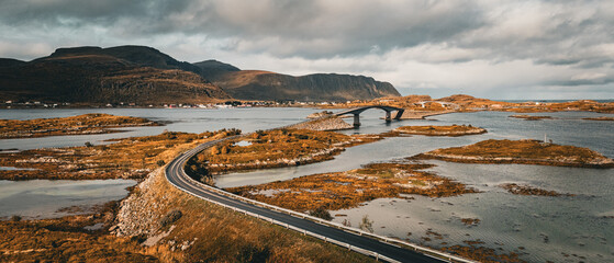 High angle view of winding coastal road and bridge connecting rocky islands in fjord landscape in Lofoten Norway © Quality by Simon