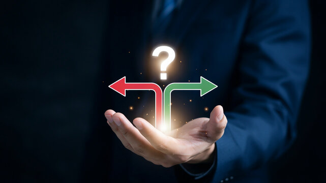 Hand holding a question mark and two diverging arrows representing choices decision crossroads