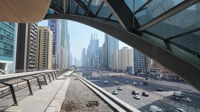 Static wide view of Sheikh Zayed Road traffic from futuristic metro station in Dubai