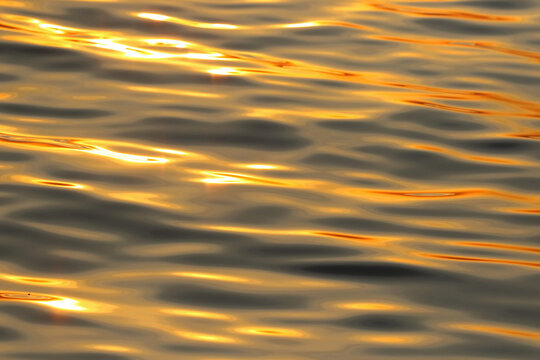 The sunlight reflects beautifully on the surface of the sea in the evening.