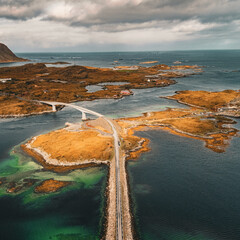 Vertical drone aerial view of coastal road and bridges connecting rocky islands in fjord landscape in Lofoten Norway © Quality by Simon