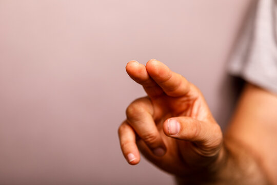 Close-up of a hand with index finger and thumb together, indicating something minimal.