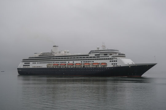 Classic luxury cruiseship cruise ship liner Zaandam Volendam arrival to Vancouver, BC after Alaska wilderness adventure Last frontier landscape nature scenery cruising with low hanging clouds misty
