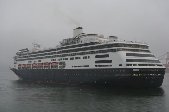 Classic luxury cruiseship cruise ship liner Zaandam Volendam arrival to Vancouver, BC after Alaska wilderness adventure Last frontier landscape nature scenery cruising with low hanging clouds misty