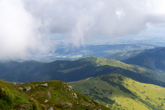 Low Clouds Rolling Over Mountain Ridge and Valley Path