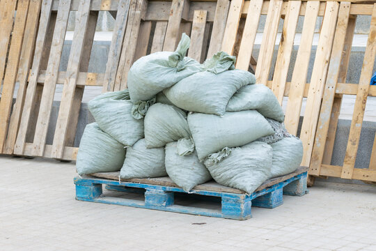 Construction debris in bags sits on a wooden pallet