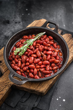 Top view of healthy vegan bean stew, garnished with fresh herbs. Moody style perfect for restaurant menus or recipe blogs.