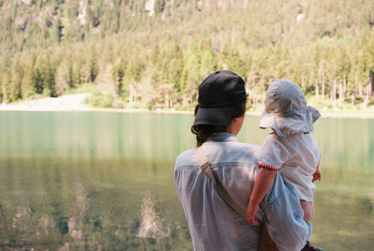 Anonymous mother and daughter near the lake