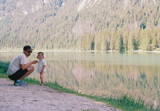 Portrait of father and child near the mountain lake