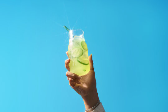 Enjoy a refreshing citrus drink on a sunny day, featuring sliced lemon