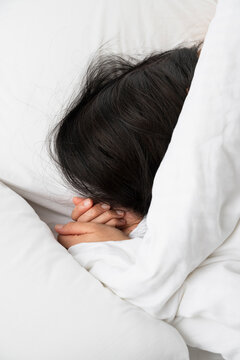 Sleeping Under Soft White Bedding