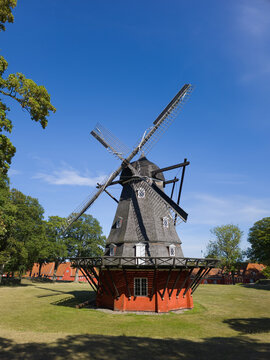 Kastellet windmill standing on a green lawn within the historic fortress in Copenhagen, Denmark, showcasing traditional Scandinavian architecture under a clear blue sky