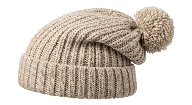 Cozy beige knitted winter hat with a fluffy pompom on top, isolated on a clean white background