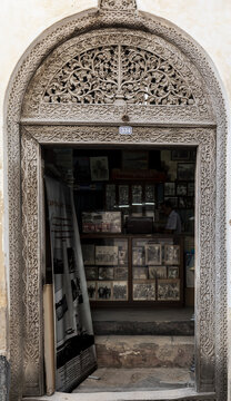 View of an intricately carved traditional wooden door frame with floral motifs in Zanzibar, Mjini Magharibi Regio, Tanzania.