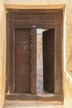 View of an ornate traditional carved wooden door with intricate patterns and the number 333 in Stone Town, Zanzibar, Mjini Magharibi Regio, Tanzania.