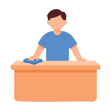 A person in a blue shirt wipes a wooden desk with a blue cloth, cleaning the surface.
