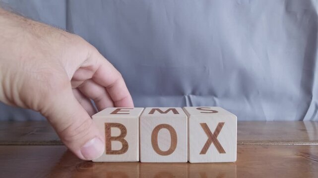 motivational word Box, laying out by hand from letters on wooden cubes, slow motion
