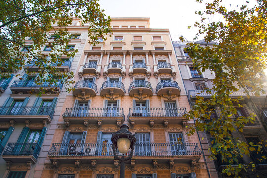 View of a classic residential building with ornate balconies and shutters in Barcelona, Catalonia, Spain.