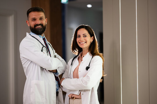 Medical team standing confidently in clinic corridor