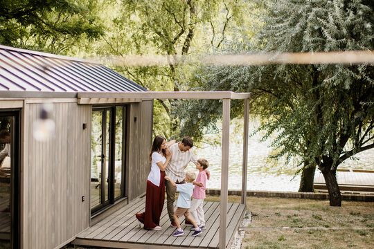Joyful family gathering near the water with laughter and love in the air