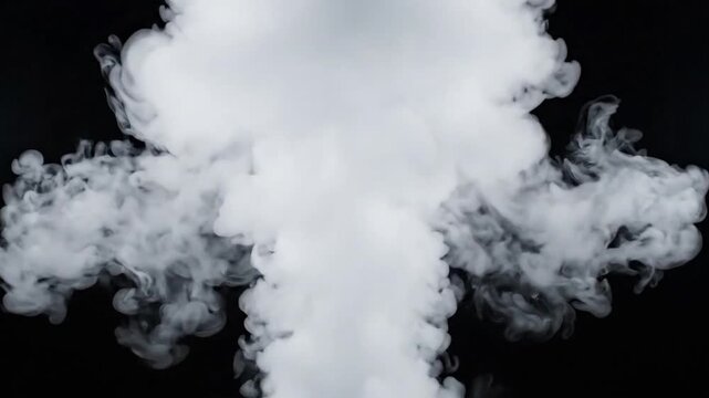 White cloud smoke rises and disperses on black background with clear details of texture and movement