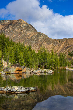 Rocky alpine lake shore beneath a Cathedral Park peak