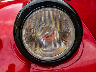 Close Up of Vintage Automobile Headlight on Classic Red Car  © sasoriprastyo