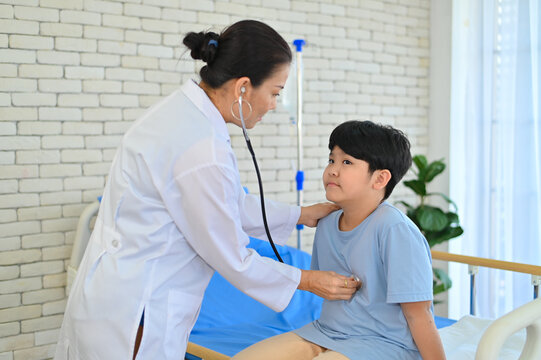 A caring doctor examines a young boy in a hospital environment, demonstrating compassion and professionalism during a health check-up session.