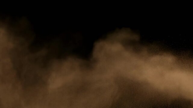 Brown dust cloud billowing with cinematic motion against a dark background
