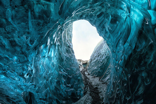 View of the vibrant blue ice walls inside the Jokulsarlon ice cave, with intricate glacial textures and natural light in Sveitarfelagid Hornafjordur, Iceland.