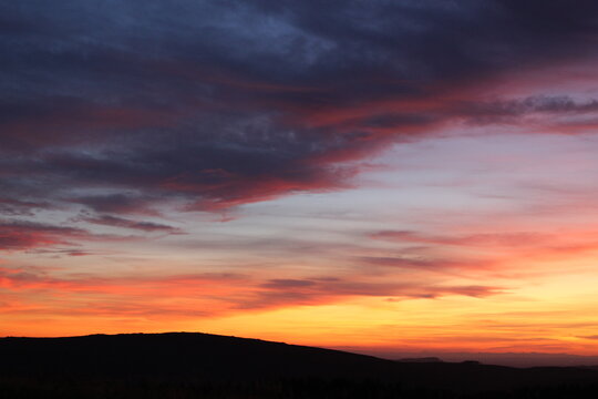 View of the sunset over the rolling hills of the Peak District National Park in England, United Kingdom.
