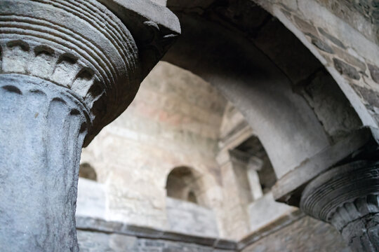Interior detail of Panagia Ekatontapyliani in Paroikia, Paros, Greece, showing ancient marble columns, carved capitals and arches within the historic Byzantine church.